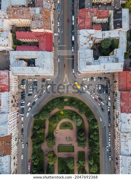 View from the top on the Turgenev square in\
Kolomna district. Residential area in St Petersburg city center.\
Rusty rooftops on old houses, asphalt road and green public garden.\
Russia in the summer.
