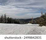 View at the top of a resort skiing and snowboarding mountain. Recreational winter sports view atop a Vermont  resort mountain overlooking the Adirondack mountains.