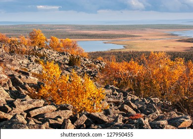 View from the top of a rocky mountain over Lapland landscape in autumn
