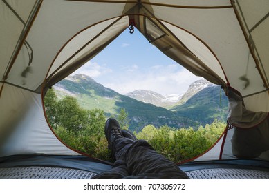 View from the tourist tent to the mountains. Guy in the boots lies on the rug