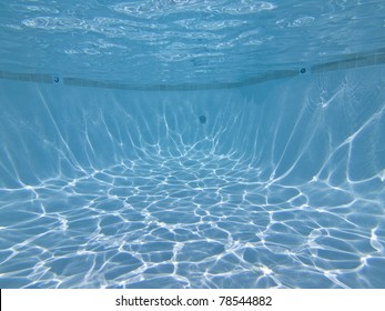 View towards the deep end of a clean swimming pool.