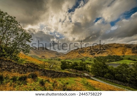 View towards the distant Langdale Pikes and Little Langdale Tarn, from the Little Langdale Valley, Lake District National Park, UNESCO World Heritage Site, Cumbria, England, United Kingdom, Europe