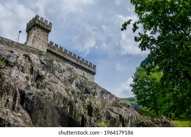 View Up Towards The Stone Walls And Tower 15th-century Sasso Corbaro Castle Above Bellinzona, Canton Of Ticino, Switzerland.