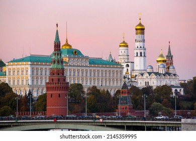 View of the tower, palace and orthodox cathedral in the Kremlin at sunset against a pink sky in Moscow, Russia