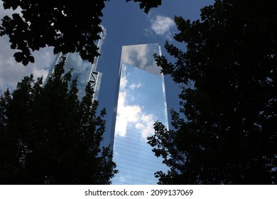 View of tower with reflection of clouds and blue sky.