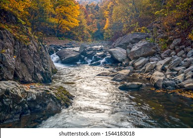A view of Toyohira river in autumn colors at the Jozankei Gensen national park, Hokkaido, Japan, With long exposure technique created movement tree leaf on the smooth river surface.  - Shutterstock ID 1544183018
