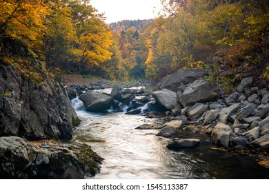 A view of Toyohira river in autumn colors at the Jozankei Gensen national park, Hokkaido, Japan, With long exposure technique created movement tree leaf on the smooth river surface.  - Shutterstock ID 1545113387