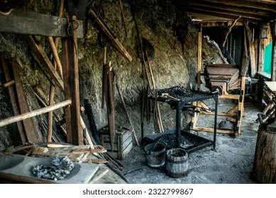 View of traditional blacksmith's shop for forging medieval iron, with furnace and an ancient bellows blower - Powered by Shutterstock