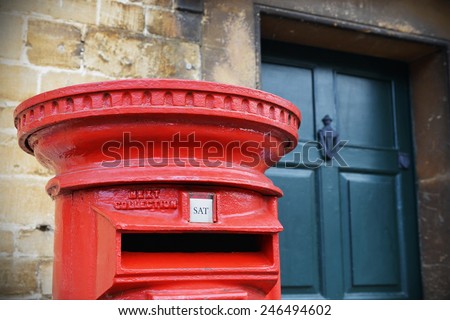 View of a Traditional British Red Post Box on a Street in an English Town