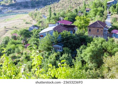 View of traditional Erzincan Kemaliye houses during the summer season. These houses, built on steep cliffs, are still used today. - Shutterstock ID 2365323693