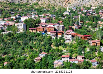 View of traditional Erzincan Kemaliye houses during the summer season. These houses, built on steep cliffs, are still used today. - Shutterstock ID 2365331125