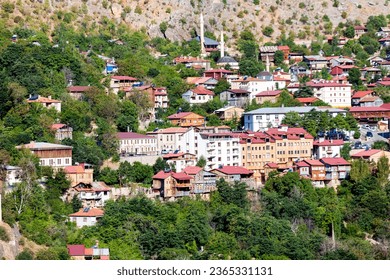 View of traditional Erzincan Kemaliye houses during the summer season. These houses, built on steep cliffs, are still used today. - Shutterstock ID 2365331131