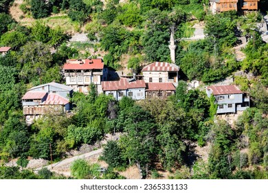 View of traditional Erzincan Kemaliye houses during the summer season. These houses, built on steep cliffs, are still used today. - Shutterstock ID 2365331133