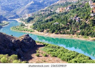 View of traditional Erzincan Kemaliye houses, the Dark Canyon and Euphrates River, during the summer season. These houses, built on steep cliffs, are still used today. - Shutterstock ID 2365339819