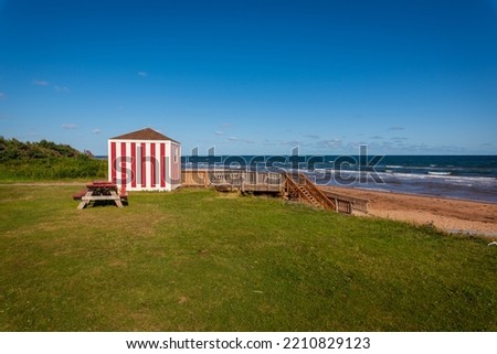 View of traditional red and white painted lifeguard station and wooden stairway down to the beautiful Stanhope Beach on the North shore of PEI in Prince Edward Island National Park of Canada.