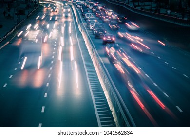 View Of Traffic Car Lights On A Busy Highway At Night. Motion Blur Soft Focus