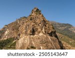 View from the trail onto a giant boulder, rock, that has a part of the road from Besisahar, Bhulbhule to Chame, Manang carved into it, close to Tal village, Annapurna Circuit Trek, Nepal 2022