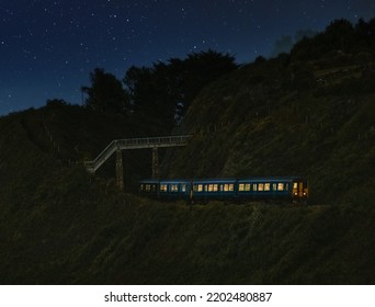 View of train moving under bridge  in mountain area on starry night - Powered by Shutterstock