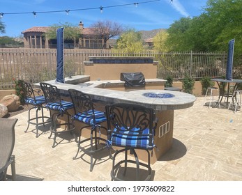 A View Of A Travertine Outdoor Kitchen With A Fire Feature Located In Arizona.