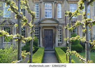 View of a Trellis Lined Garden Path Leading to an Old Country House