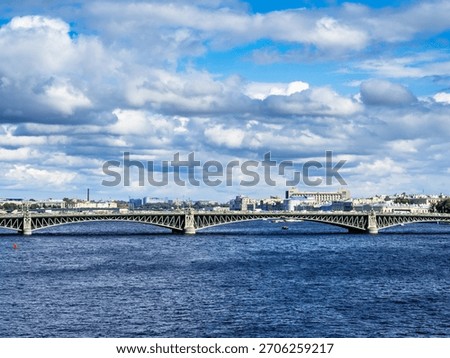 view of Trinity Bridge across Neva river in Saint Petersburg city, Russia on cloudy sunny summer day