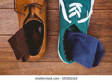 View Of Two Different Shoes On Wood Plank