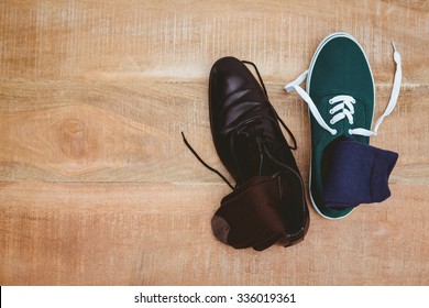 View Of Two Different Shoes On Wood Plank