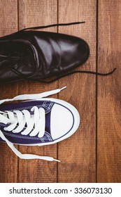 View Of Two Different Shoes On Wood Plank