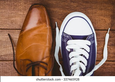 View Of Two Different Shoes On Wood Plank