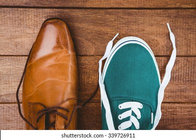 View Of Two Different Shoes On Wood Plank