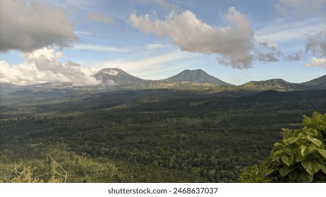 view of two mountains covered in clouds