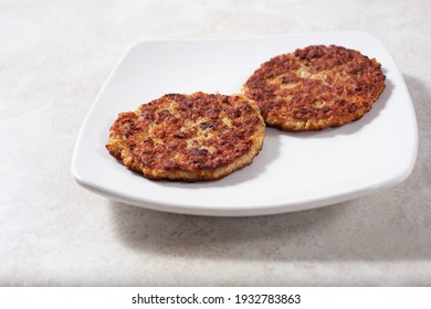 A View Of Two Sausage Patties On A Plate.