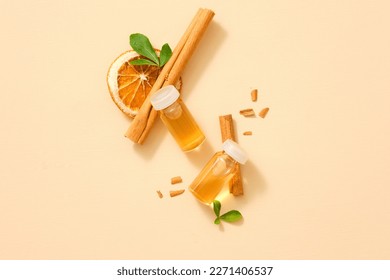 A bird’s-eye view of two transparent jar of cinnamon (Cinnamomum) stick and dried orange slice extract. Concept for natural, organic beauty products.