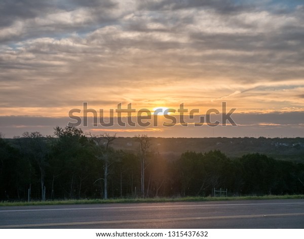 View of\
Two Way Road With Sunrise in the\
Background
