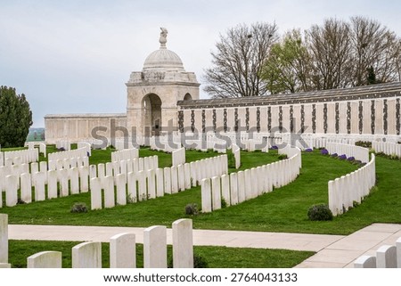 View of the Tyne Cot Memorial featuring a domed pavilion and rows of white Commonwealth headstones. Located in Zonnebeke, it is the world's largest British military cemetery, honoring WWI fallen in Flanders, Belgium. UNESCO World Heritage site.