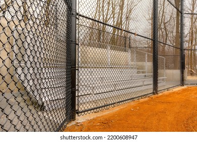 View Of Typical Nondescript High School Softball Field Aluminum Bleachers Located Behind The Backstop.  No People Visible.  Not A Ticketed Event.	 