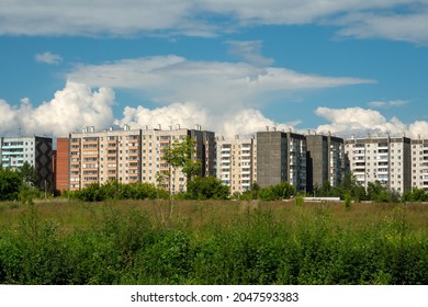 View of typical residential apartment buildings and the vacant lot in front of them on a sunny summer day. - Shutterstock ID 2047593383