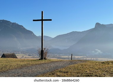 View of a typical summit cross and the mountain Ettaler Mandl in Bavaria