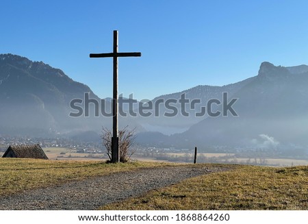 View of a typical summit cross and the mountain Ettaler Mandl in Bavaria