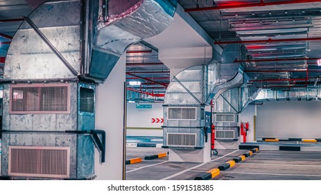 View Of An Underground Industrial Floor Level As A Car Parking Space With Ventilation And Firefighting Equipment Exposed