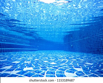 view underwater the pool empty background blue water transparent. and mosaic tiles blend ocean.