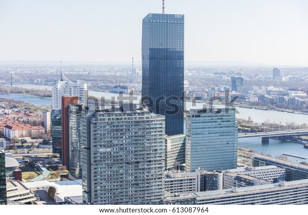 View of the UNO city complex including VIC,\
Donauturm, UN headquarters and a riverside promenade full of bars\
and restaurants in Vienna,\
Austria.