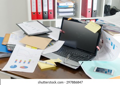 View of a untidy and cluttered desk - Shutterstock ID 297886847