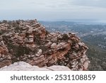 View of unusual pink rocks with an observation deck on top and wooden hills and endless valleys