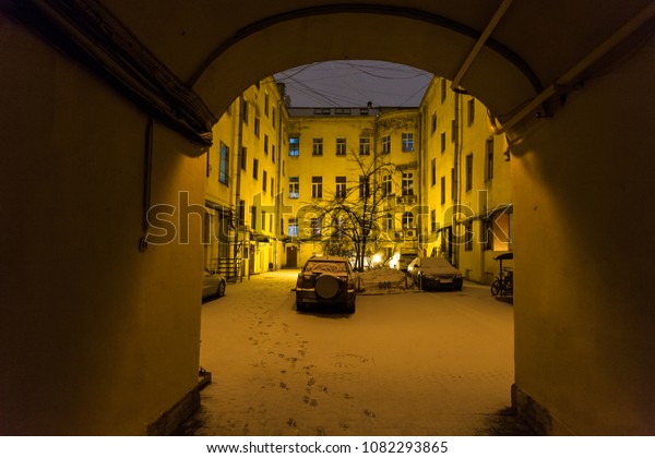 view of urban patio in St Petersburg city in\
night snowfall