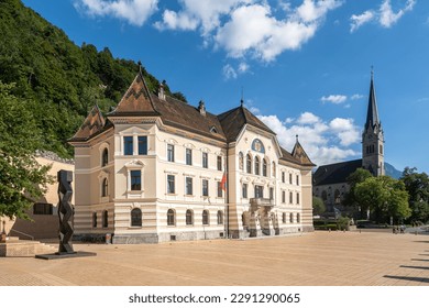 View of Vaduz, the capital of Liechtenstein. On the left, the government building, on the right, the St. Florin Cathedral - Powered by Shutterstock