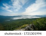 view of the valley from the height of the mountain range in fog