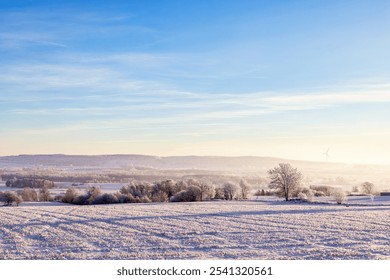 View of a valley in a rural landscape with snow and hoarfrost on a cold foggy winter day - Powered by Shutterstock