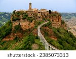 View of the valley and town of Civita di Bagnoregio with stone houses on a high cliff in the province of Viterbo, Lazio region, Italy