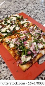 View Of Veggie Flatbread Pizza With Red Onions Green Peppers And Cheese